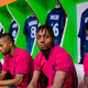 Sporting Lagos players dressed in pink while seated in their locker room before their first official game